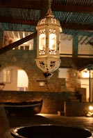 Lantern hanging from pergola