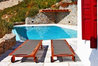 Loungers by swimming pool
