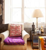 Colourful cushions on armchair