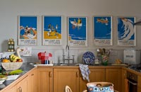 Colourful vintage  posters in kitchen