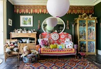 Colourful sofa surrounded by collectibles