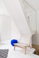 Woven chair under staircase