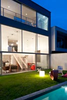 Contemporary house and garden lit up at night