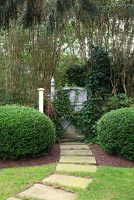 Garden path flanked by clipped shrubs