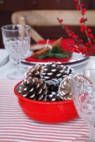 Bowl of pine cones on christmas table