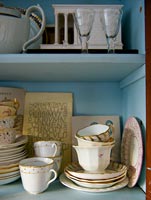 Patterned tableware on kitchen shelves