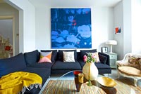Modern living room with abstract painting by Ylva