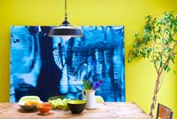 Colourful dining room with abstract painting by Ylva