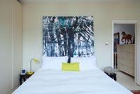 Modern bedroom with abstract painting by Ylva