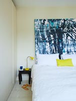 Modern bedroom with abstract painting by Ylva