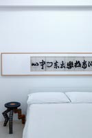 Oriental artwork above bed