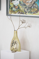Dried flower heads in patterned vase