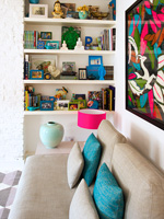Colourful display of accessories on living room shelves