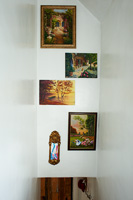 Display of paintings on stairwell