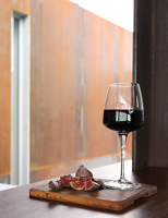 Figs and wine on wooden chopping board