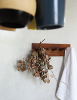 Dried foliage hanging from wooden hooks