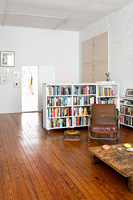 White bookcase in open plan apartment