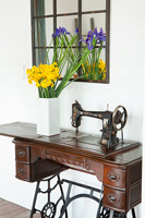Daffodils and Irises in vase on vintage sewing machine