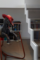 Vintage rocking horse by modern staircase