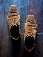 Suede shoes on dark wood floor