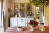 Dining room with vintage sideboard and portrait paintings