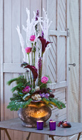 Christmas flower arrangement with conifer foliage, Roses, Calla lilies and pine cones