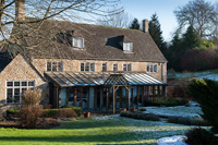 Country house with conservatory in winter
