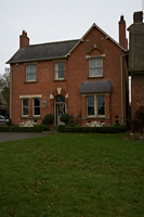 Red brick house and lawned garden