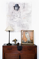 Portrait above vintage wooden cabinet