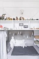 White childs bedroom with storage above bed