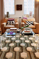 Glass coffee table on patterned carpet