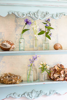 Floral display on painted shelves