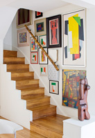 Modern wooden staircase with art display