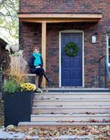 Holly Wheatcroft sitting on front porch