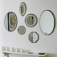 Collection of antique mirrors above fireplace