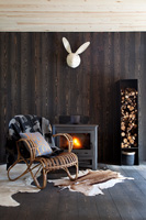 Cane armchair by wood burning stove
