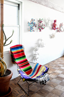 Metal chair with colourful throws