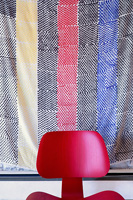 Wall hanging behind red chair