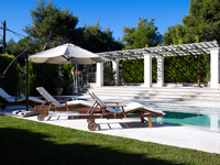 Loungers by swimming pool