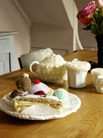 Knitted cakes on wooden dining table