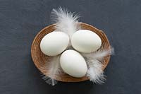 White eggs in wicker bowl