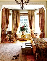 Classic bedroom with gold curtains