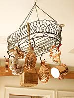 Copper utensils hanging from wire basket