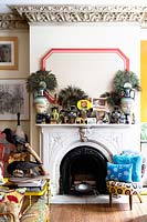 Eclectic ornaments and artworks on mantlepiece