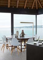 Contemporary dining room overlooking sea