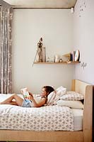 Girl reading on her bed