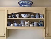 Display of patterned crockery on kitchen shelves