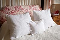 Patterned cushions on bed