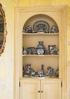 Patterned ceramics displayed in cabinet
