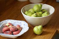 Bowls of pears and asian peaches